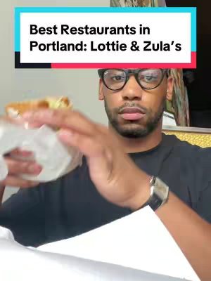 A man in a black shirt and glasses is holding a sandwich wrapped in paper. Text overlayed on the top of the image in a rectangle that shows the video is about restaurants.