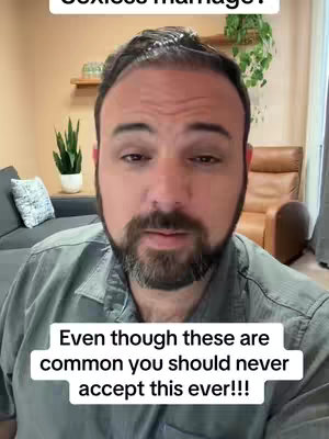 A man with dark hair and a beard is speaking directly to the camera in a medium shot. He is wearing a collared shirt. Below him, there is a white frame with text overlaying the image.