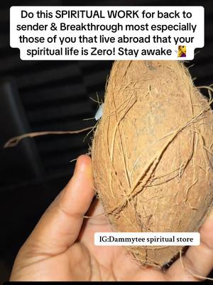 The image shows a close-up view of a person's hand holding a brown, textured coconut. The background is dark, and a text overlay at the top urges viewers to do 'SPIRITUAL WORK.'