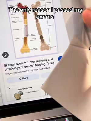 A person's hand is partially visible, holding up a laptop screen that displays an image of the skeletal system. The screen shows an illustration of a femur, with labels highlighting different parts like the 'compact bone' and 'spongy bone'. Overlayed on the image is text, suggesting the video is about studying or learning.