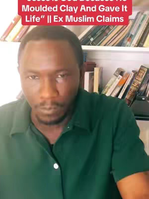 A man with a serious expression is centered in the frame, wearing a dark green collared shirt. Behind him, a bookshelf is visible, filled with books. A red banner with white text is superimposed at the top.