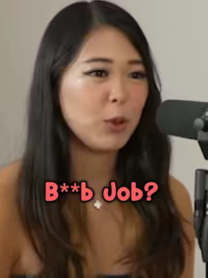 The cover image features a woman with dark hair and fair skin, framed from the chest up, with a light background. The text overlay reads "B**b Job?" in a playful font, centered below her face. A microphone is visible to the right of the frame.