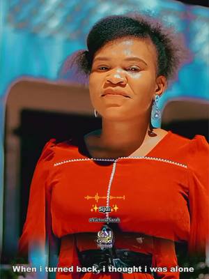 A woman in a red dress stands facing the camera with a serious expression. Text overlays include the song title and social media handles on the front, with an additional text at the bottom.