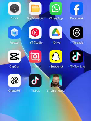 A screenshot of a phone home screen filled with various app icons. The icons are arranged in a grid, with app names displayed beneath them. The background is a gradient of blue and yellow. The focus is on the various app icons displayed.