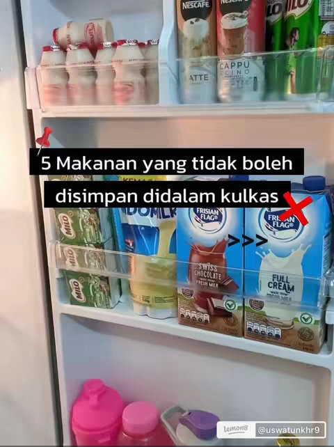 A refrigerator with various food items visible on the shelves.  There are cartons of milk and other dairy products, some with a red 'X' mark, along with other food items displayed in the refrigerator shelves.