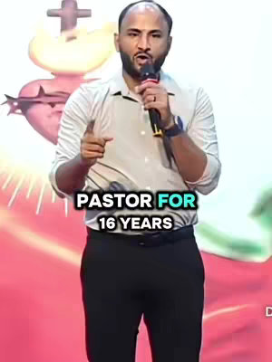 The image features a man with a shaved head, wearing a light-colored button-down shirt and dark pants. He is holding a microphone in his right hand and pointing with his left index finger. A religious symbol is visible in the background, and overlayed text states "PASTOR FOR 16 YEARS."