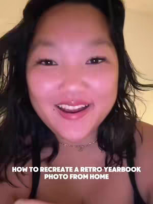 A young woman with long dark hair is smiling and looking directly at the camera. The image is lit with soft, warm lighting. The text overlayed on the image reads, "HOW TO RECREATE A RETRO YEARBOOK PHOTO FROM HOME".