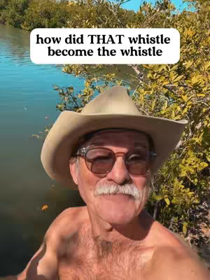 A selfie-style shot of a man in a cowboy hat and sunglasses, smiling with a body of water and greenery in the background. Text overlay on the top of the image: how did THAT whistle become the whistle