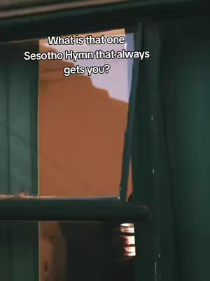 The image is a vertical shot looking through a window frame. The frame is dark green, and the window is open. The background shows a tan-colored wall. In the frame's opening, text is overlaid, asking a question in white against the dark background.