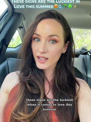 A woman with long brown hair is seated inside a car, looking at the camera with a slight smile. Text overlays are present. The background shows an outdoor scene.