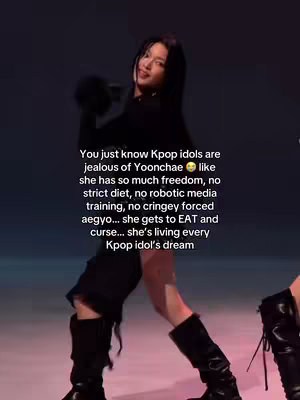 A woman in a black outfit is captured in a dynamic pose. She appears to be dancing or moving on a colored background. The image's composition focuses on her figure, with text overlaying the image to describe the scene and its context.