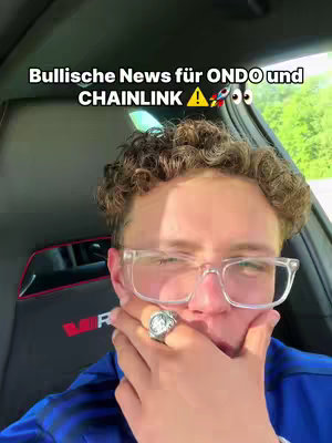 A selfie-style cover image featuring a young man in a car. He's wearing clear-framed glasses and a large silver ring. The background shows the inside of the car and some foliage. A text overlay at the top says, "Bullische News für ONDO und CHAINLINK!" with space and a rocket emoji.