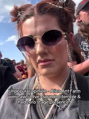 A selfie-style shot featuring a young woman with auburn hair styled in space buns. She's wearing round sunglasses with chain details, and a gray top. Text overlays are added at the bottom.