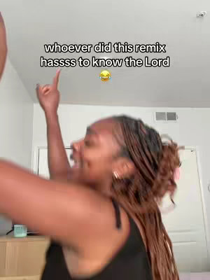 A woman with braided hair is captured mid-dance with her arm raised, pointing upwards. The image is a selfie, with a light-toned background possibly indicating an indoor setting. Text overlays in white above the woman read 'whoever did this remix has to know the Lord'.