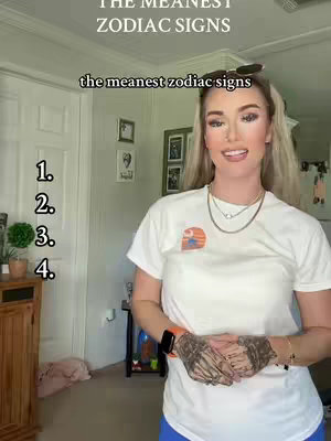 A woman with blonde hair, wearing a white t-shirt, stands in front of a light-colored green wall. The top of the frame has the text "THE MEANEST ZODIAC SIGNS". Below the woman is a list of numbers.