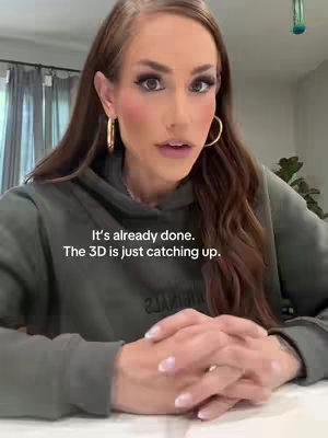A woman with long brown hair wearing a green hoodie is looking at the camera with a sincere expression. The text overlay says, "It's already done. The 3D is just catching up."