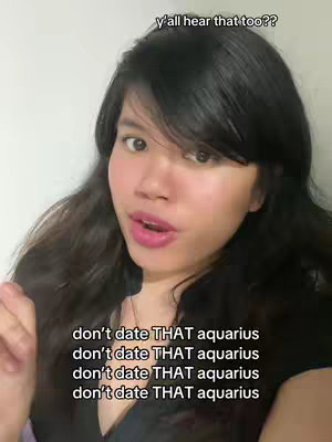 The cover image features a young woman with long dark hair, slightly smiling with pink lipstick, looking directly at the camera with a slight tilt of her head. Above her are the words ''y'all hear that too??''. The lower part of the image repeats the phrase: “don’t date THAT aquarius”. The lighting is soft and creates a casual, social media-style frame.