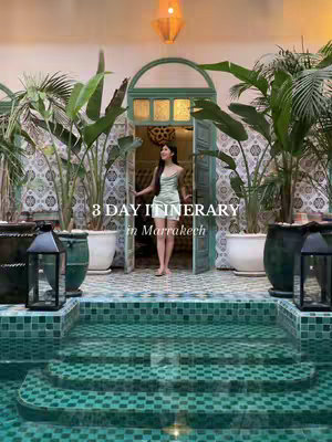 A woman stands in an ornate doorway, which opens to a lush green garden. The doorway is teal and flanked by potted plants. Below, a pool with teal mosaic tiles adds depth to the image. Text overlayed informs that this is of a 3-day itinerary in Marrakech.