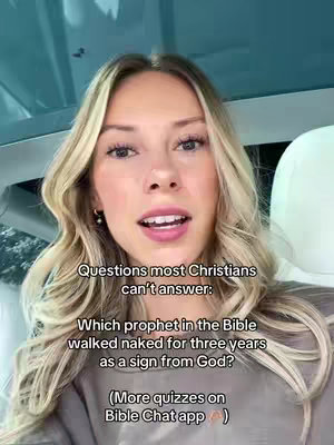 A young woman with blonde hair is centered in the frame, looking directly at the camera. Text overlays partially obscure her, positioned above and below her face. The background appears to be inside a vehicle, with a clear view of the sky through the windshield.