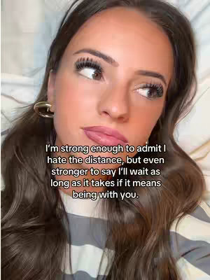 A close-up shot of a woman lying down, looking off to the side with makeup on, and a text overlay on display.