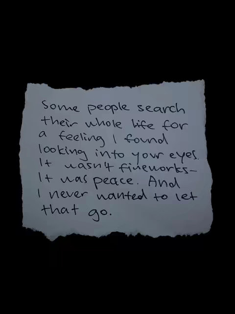 A piece of torn paper with handwritten text on a black background. The paper is slightly crumpled with uneven edges, suggesting it has been handled. The text is written in a casual, cursive style and forms a poem or quote. The contrast is stark due to the white paper against the black background, making the text highly visible and the message a central focus.