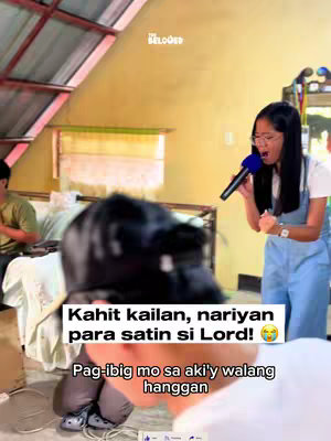 The image is a selfie-style shot taken indoors. A young woman is holding a microphone and singing, with what appears to be an emotional expression. In the foreground, there is a blurred image of a person bending over. Text overlays are added to the image to convey a message.