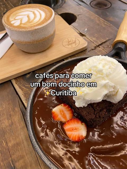 The cover image features food, including a brownie topped with ice cream and strawberries in a skillet, alongside a cappuccino on a wooden board, all placed on a wooden table.