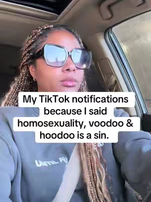 A woman with braided hair and large sunglasses is seated inside a car, the shot taken from a first-person perspective. Text overlaying the image reads: 'My TikTok notifications because I said homosexuality, voodoo & hoodoo is a sin.'