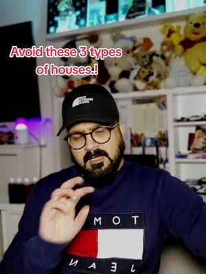The video cover shows a man with glasses, beard, and a black cap, gesturing with his right hand. Text overlayed reads: 'Avoid these 3 types of houses..!' The background has a TV screen, a shelf with stuffed toys.