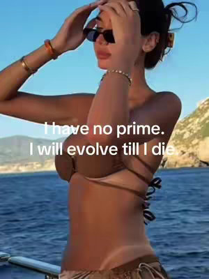 A woman in a bikini and sunglasses is on a boat, looking away from the camera. The background includes the ocean and a partly visible island, with text overlayed.