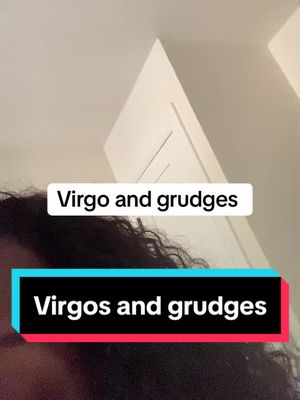 The image displays a person's face with the top of their head in frame, the background is a plain wall and the edge of a white door. It features two overlaid text boxes: the first says "Virgo and grudges" in a white rectangle, and the second says "Virgos and grudges" in a rectangle with a teal top and pink bottom.