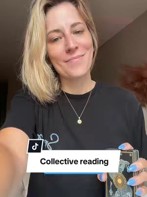 A woman with blonde hair, wearing a black t-shirt, holding a deck of cards in her right hand and looking towards the camera with a slight smile. A text overlay reads 'Collective reading' in a white box. The background appears to be a room with soft lighting.