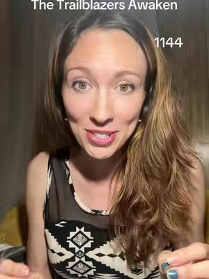 A woman is centered in the frame, facing the camera with a slight smile. She has light skin, brown hair styled with some waves, and is wearing a black top with a white geometric pattern. The background is a blurred, warm tone. Text overlays at the top right and bottom of the image.