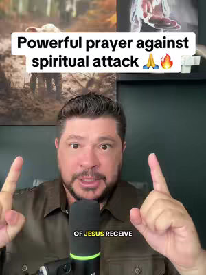A man in a brown shirt directs the viewer with both index fingers up. Above him, the title overlayed says: Powerful prayer against spiritual attack, with illustrations of praying hands and a flame.