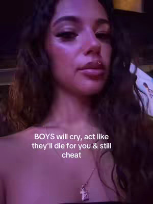 A close-up shot of a woman with dark hair and a piercing on her lip. Text overlayed at the bottom of the image and a necklace.