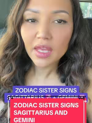 A woman with long brown hair and makeup looks at the camera. Overlayed on the video are two rectangular text boxes: one purple, with the text 'ZODIAC SISTER SIGNS', and a second one, red, which reads 'ZODIAC SISTER SIGNS, SAGITTARIUS AND GEMINI'.