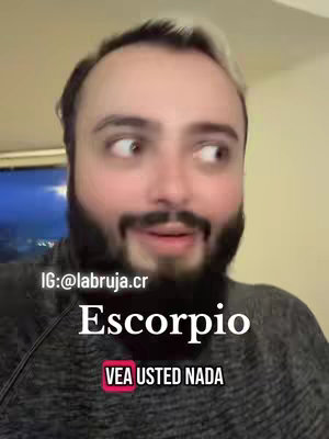 A close-up of a man with a beard and highlighted hair looking to the side with a surprised expression. Text overlays reveal the astrological sign 'Escorpio' and 'Vea Usted Nada'.
