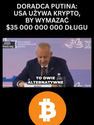 The image is a news-style graphic with a man speaking at what appears to be a conference or press event. Overlayed text announces that an advisor to Putin claims the US is using crypto to erase its debt with a large dollar amount specified. There is a Bitcoin logo at the bottom of the image which has a black background.