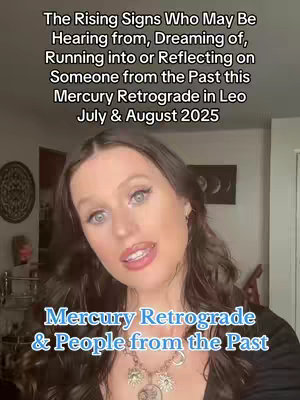 A woman with long brown hair and fair skin is centered in the frame, speaking to the camera. Behind her is a partial interior, with a decorative item on the wall. Text overlays at the top and bottom provide context for the video's astrological theme.