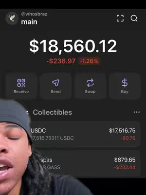The cover image shows a person with dreadlocks in front of a mobile app screen. The screen displays account information, including a balance of $18,560.12, with a red-colored negative change. The app interface has action buttons to receive, send, swap, and buy crypto. The person has a serious expression, and is wearing a black cap.