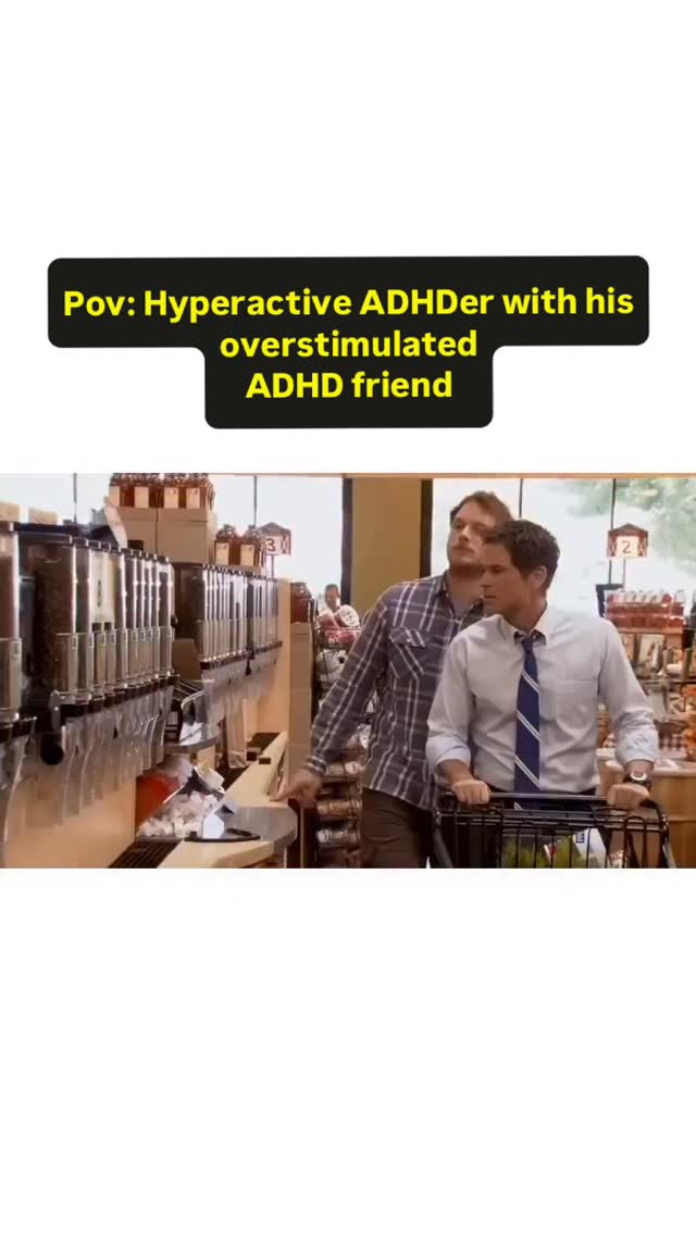 A scene from the show 'Parks and Recreation,' featuring two male characters in a supermarket setting. One man pushes a shopping cart while the other stands next to the cart. Text overlay reads 'Pov: Hyperactive ADHDer with his overstimulated ADHD friend'. The background features supermarket shelves, bright lighting, and other shoppers.