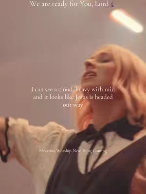The image captures a person with blonde hair, facing upwards towards a bright, out-of-focus light source. The person is wearing a top with a dark bow and white elements. Text overlays include religious verses and song lyrics.