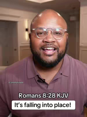 A medium shot features a man with a bald head and glasses, smiling toward the camera, against a blurred indoor background. Text overlays read "Romans 8:28 KJV" and "It's falling into place!".