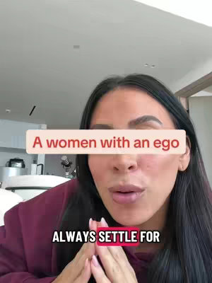 A woman looking directly at the camera with text overlays. The top text is a red rectangle that obscures a portion of the background and the woman's face. The background includes a white ceiling.