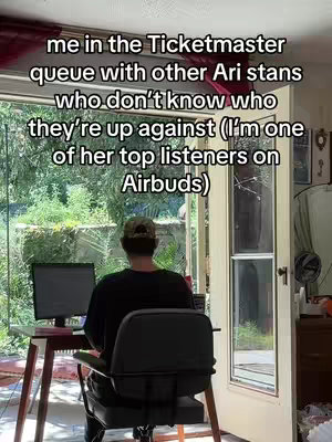 The cover image shows a person sitting at a desk with a laptop, facing away from the camera. The person is wearing a dark shirt and a baseball cap. The desk is positioned in front of an open doorway or large window, providing a view of a lush green outdoor area. The room appears to be brightly lit, and the overall composition is casual and informal.