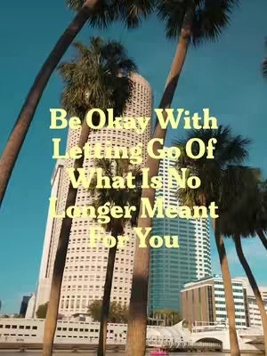An eye-level shot of a city skyline framed between palm tree trunks with text overlay on the image.