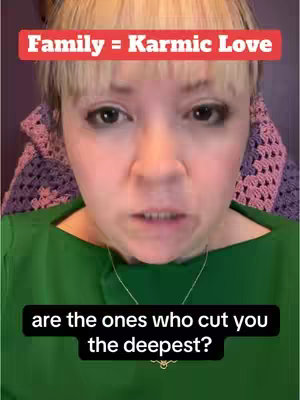 A woman with blonde hair and bangs looks directly at the camera with a neutral expression. Above her is a red rectangle with white text that reads "Family = Karmic Love." Below her is a black rectangle with white text: "are the ones who cut you the deepest?"