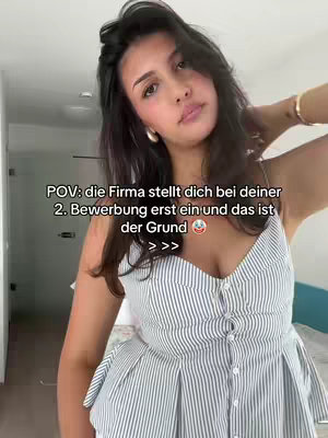 A young woman with dark hair poses in a well-lit room. She's wearing a white and blue striped top and gold hoops. The text overlay reads 'POV: die Firma stellt dich bei deiner 2. Bewerbung erst ein und das ist der Grund'.