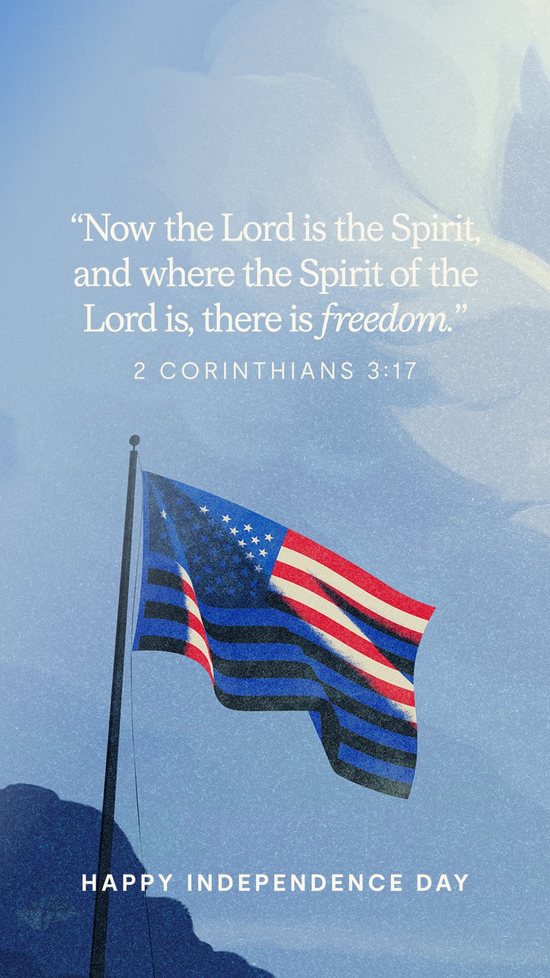 The cover image is a vertical composition featuring a stylized American flag waving against a soft blue sky background. The flag's design incorporates a blue section with stars, and red and white stripes, though the shades are muted and artistic, blending with the overall color scheme. Text overlays are centered, with a quote from 2 Corinthians 3:17 in a clean white font. The phrase 'HAPPY INDEPENDENCE DAY' is at the bottom, also in white.