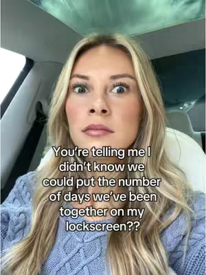 A woman with blonde hair and a blue knit sweater sits inside a car looking directly at the camera with a surprised expression. Text overlays the image.